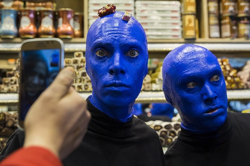 Blue Man Group snaps selfies with locals