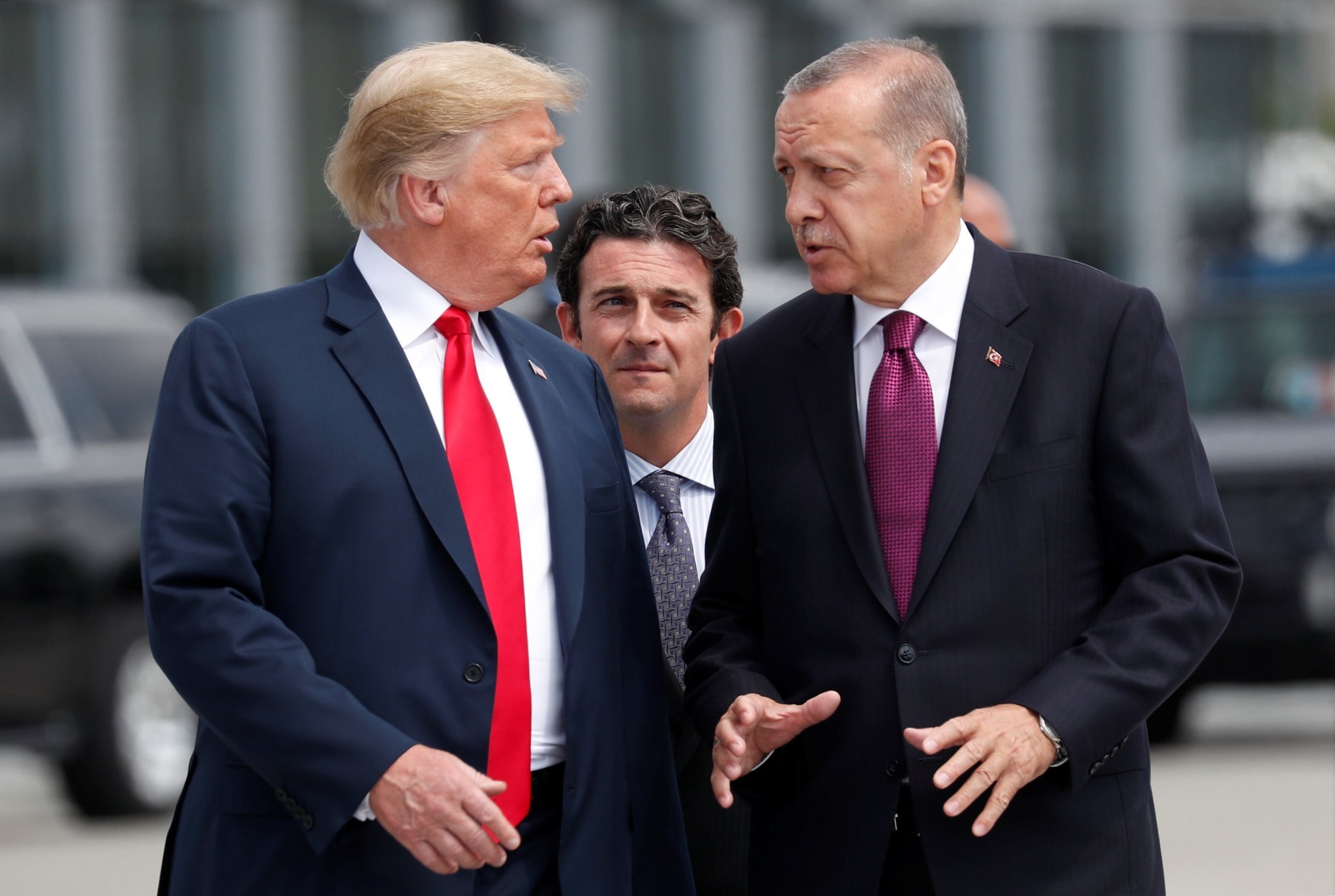 U.S. President Donald Trump (L) and President Recep Tayyip Erdou011fan gesture as they talk at the start of the NATO summit in Brussels, Belgium, July 11. 