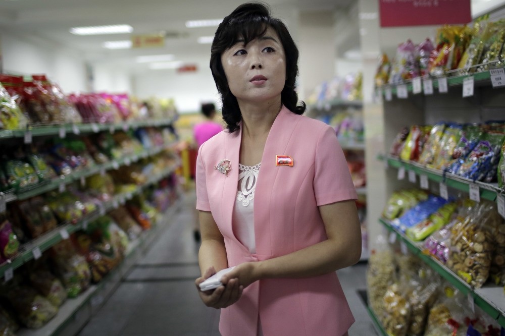 Song Un Pyol, manager at the Potonggang department store, stands in the snacks aisle while being interviewed by The Associated Press in Pyongyang.