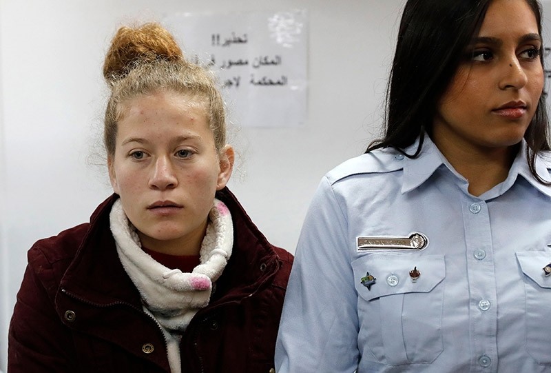 Ahed Tamimi (L), a 17-year-old prominent Palestinian campaigner against Israel's occupation, appears at a military court at the Israeli-run Ofer prison in the West Bank village of Betunia on December 25, 2017. (AFP Photo)