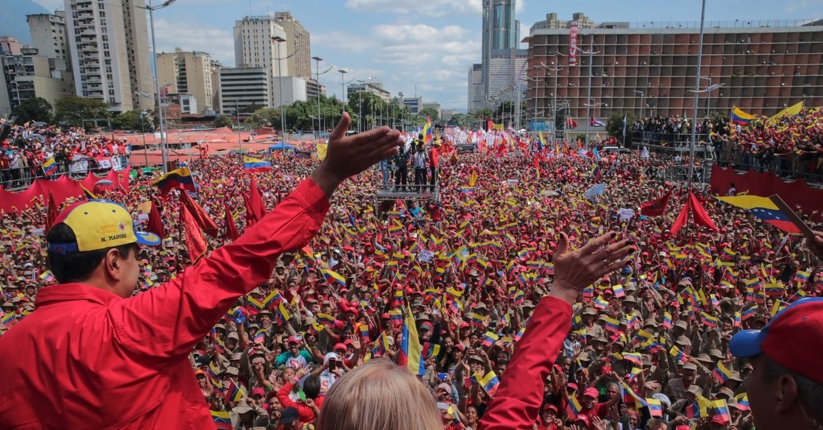 Venezuelan President Nicolas Maduro (L) and his wife Cilia Flores wave at the crowd during a gathering to mark the 20th anniversary of the rise of power of the late Hugo Chavez, in Caracas, Feb. 2, 2019.