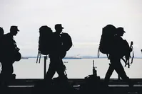 Soldiers line up on a military ship. Male Turkish citizens are required to fulfill their obligatory military service, but would it be possible to use this manpower in other military areas?