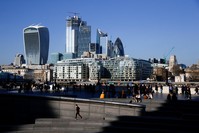 The financial district seen in the background as a jogger runs on London's South bank, Feb. 23, 2019.