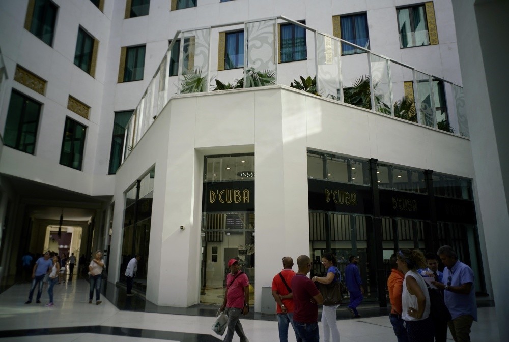 People look at luxury storefronts at the Manzana de Gomez Kempinski five-star hotel in Havana, Cuba.