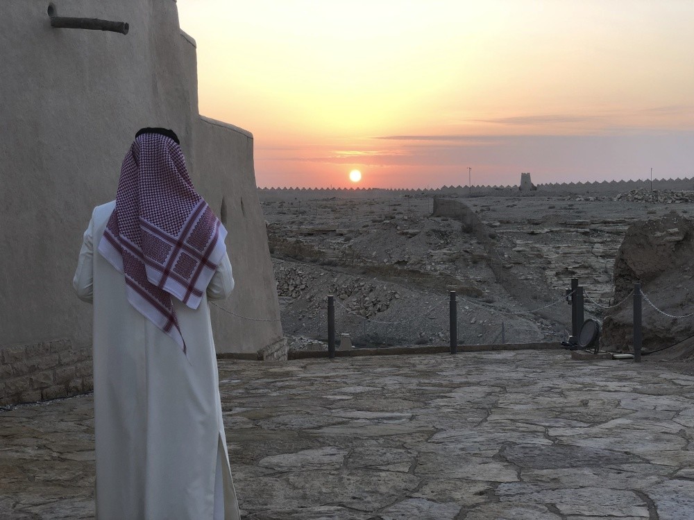A Saudi man watches the sun setting over Dhiriyah, Riyadh, Saudi Arabia, Dec. 16.