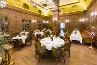 High ceilings with carvings, long pillars, dim lighting, antique sculptures and stylish chairs are distinctive decorative features of Galvin.