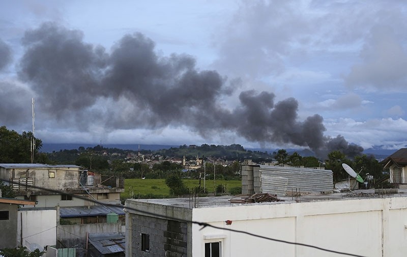 Black smoke from air strikes fills the sky as fighting continues in Marawi city, southern Philippines Friday, June 9, 2017. (AP Photo)