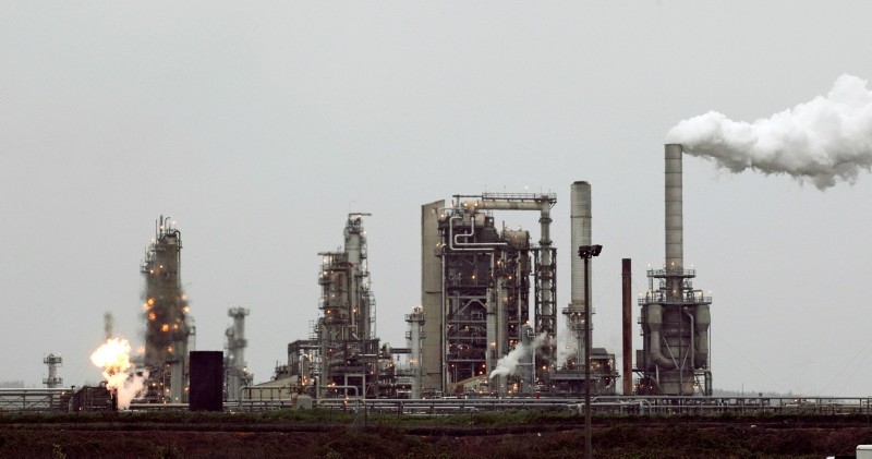 This April 2, 2010 file photo shows a Tesoro Corp. refinery, including a gas flare flame that is part of normal plant operations, in Anacortes, Wash. (AP Photo)