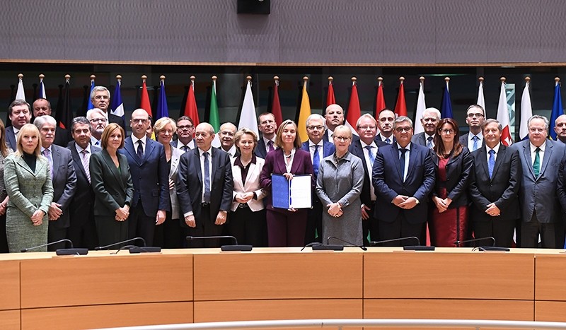 EU foreign policy chief Federica Mogherini (C) poses with foreign and defense ministers from 23 EU member states after they signed the notification on Permanent Structure Cooperation (PESCO), Brussels, Belgium, Nov. 13, 2017. (EPA Photo)