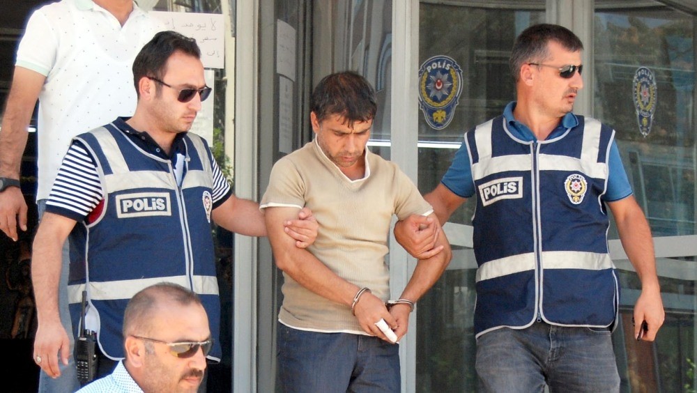 Police officers escort Kayapu0131nar after his arrest.