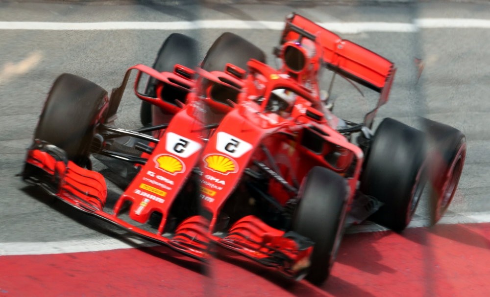 Ferrari's Sebastian Vettel is reflected in the pitlane during testing.