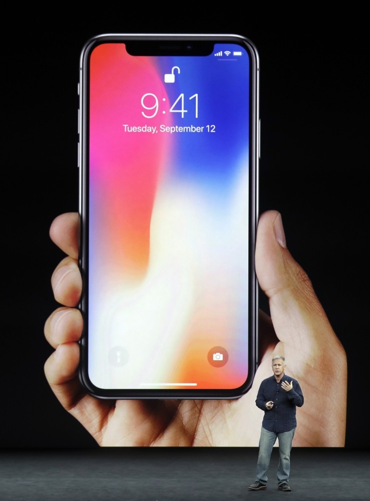 Phil Schiller, Apple's senior vice president of worldwide marketing, announces features of the new iPhone X at the Steve Jobs Theater on the new Apple campus on Tuesday.
