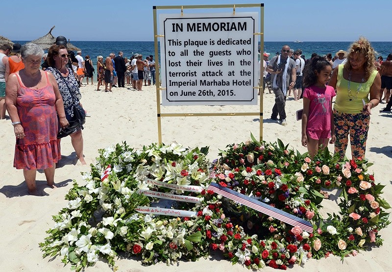 This file photo taken on July 03, 2015 shows tourists and Tunisians taking part in a ceremony on July 3, 2015, in memory of those killed the previous week by a jihadist gunman in front of the Riu Imperial Marhaba Hotel. (AFP Photo)