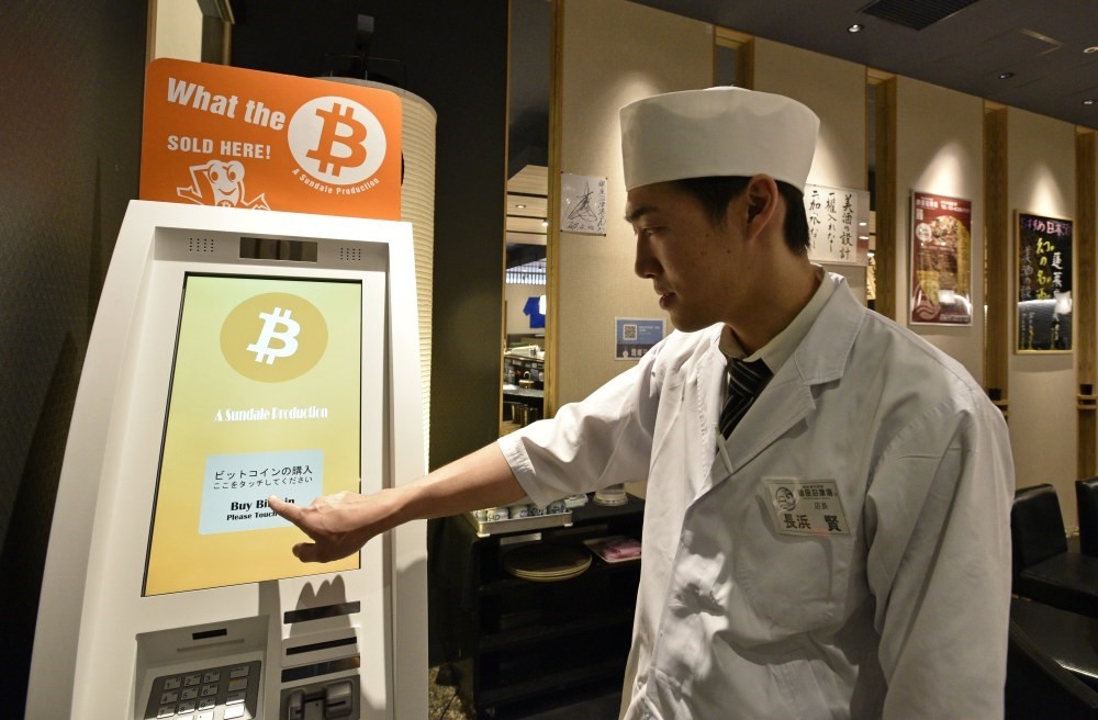Ken Nagahama, Numazuko Ginza sushi restaurant manager, demonstrates the Bitcoin purchase system at his restaurant in central Tokyo.