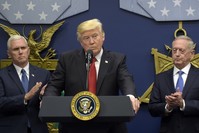 U.S. President Donald Trump (C) accompanied by Vice President Mike Pence (L) and Defense Secretary James Mattis (R) as he speaks during an event at the Pentagon in Washington, D.C., Jan. 27.