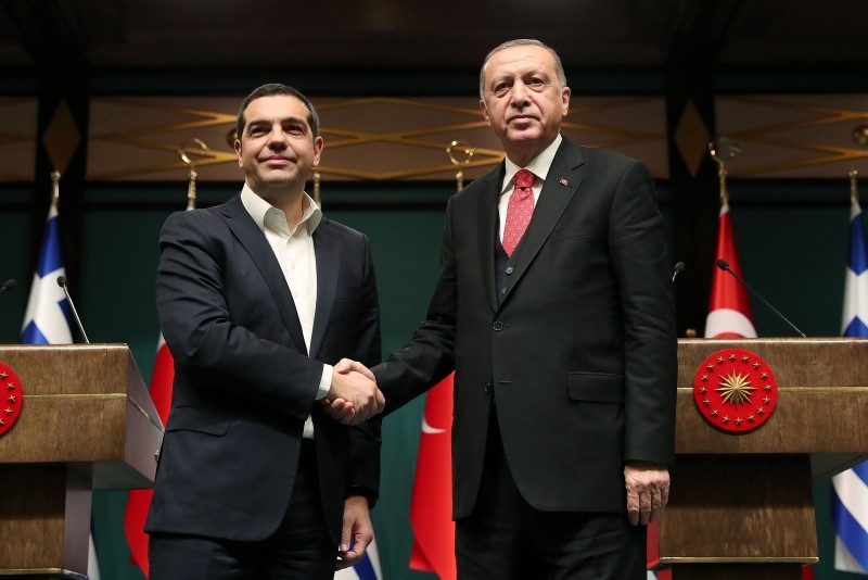 A handout photo released by the Turkish President's press office on February 5, 2019 showsErdou011fan (R) shaking hands with Tsipras during a press conference at the presidential complex in Ankara. (AFP Photo)