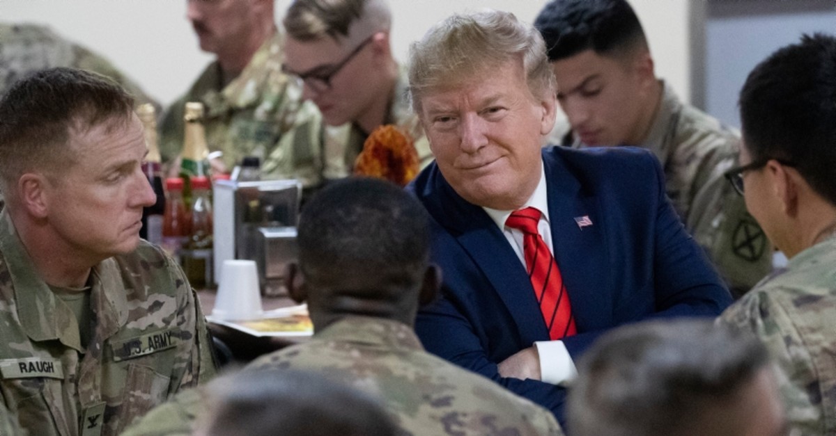 President Donald Trump smiles while sitting with the troops during a surprise Thanksgiving Day visit to the troops, Thursday, Nov. 28, 2019, at Bagram Air Field, Afghanistan. (AP Photo)