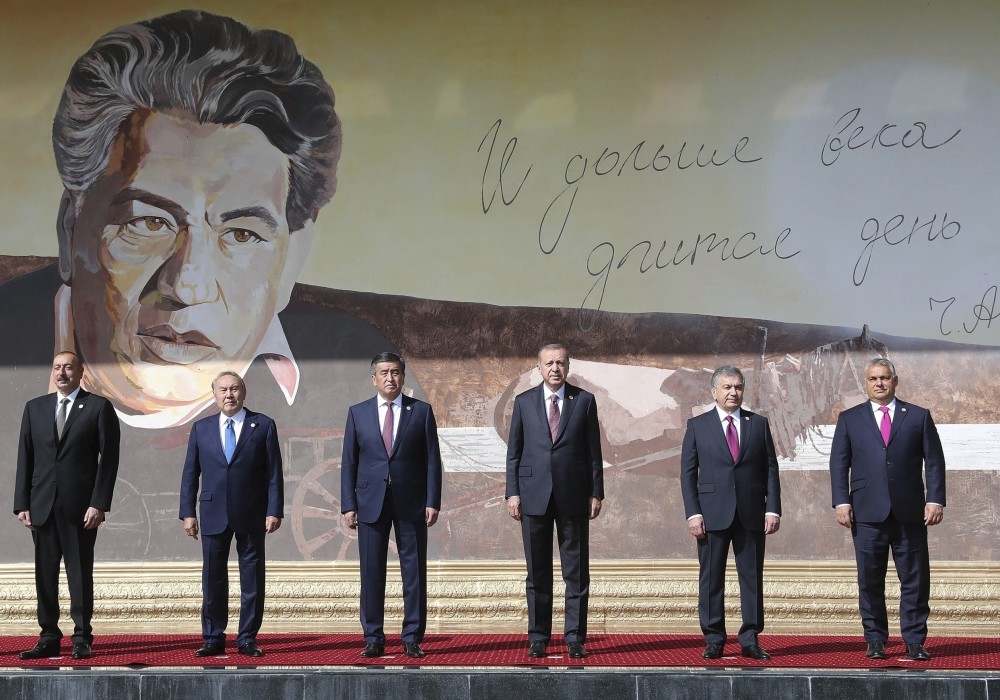 Azerbaijanu2019s Aliyev, Kazakhstanu2019s Nazarbayev, Kyrgyzstanu2019s Jeenbekov, President Erdou011fan, Uzbekistanu2019s Mirziyoyev and Hungaryu2019s  Orban pose for a photo in front of a portrait of Chingiz Aytmatov, a Kyrgyz author and diplomat
