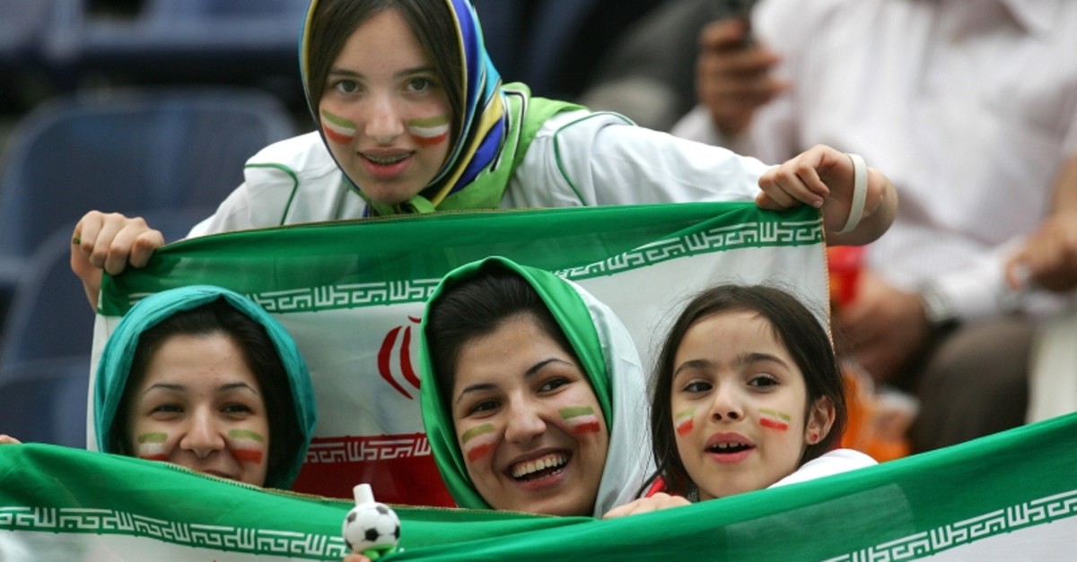 Iranian women wave national flags prior to the Portugal v Iran Group D soccer match at the World Cup  stadium in Frankfurt, Germany, Saturday, June 17, 2006. (AP Photo)