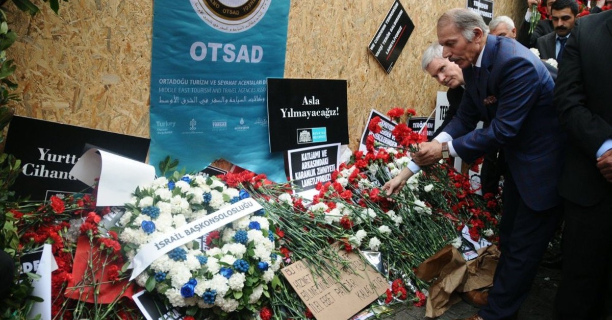 People leave flowers at the site of the bombing, March 22, 2016.