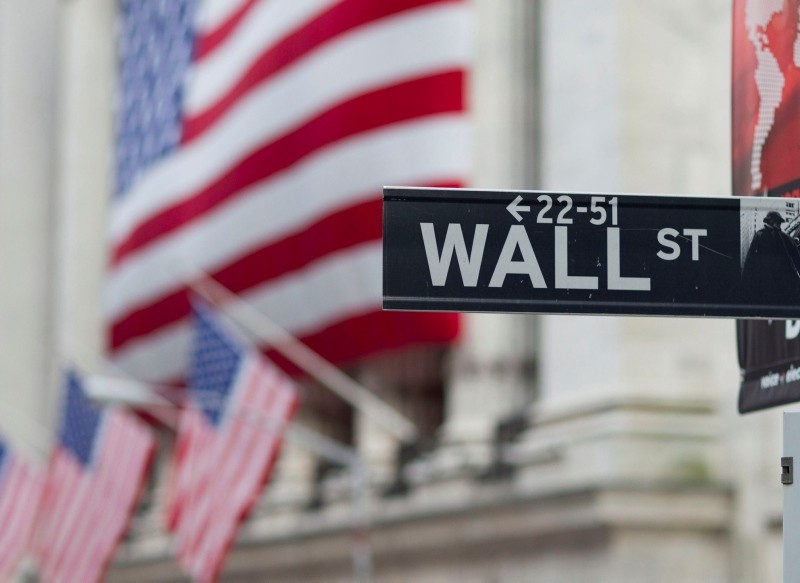 In this Aug. 8. 2011 file photo, a Wall Street sign hangs near the New York Stock Exchange, in New York. (AP Photo)
