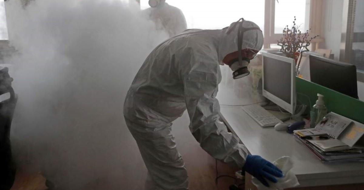 Workers with sanitizing equipment disinfect an office following an outbreak of the coronavirus, Shanghai, Feb. 12, 2020. (REUTERS Photo)
