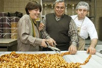 Mary Iu015fu0131n (L) helps chefs cut a traditional Ottoman sweet into pieces.