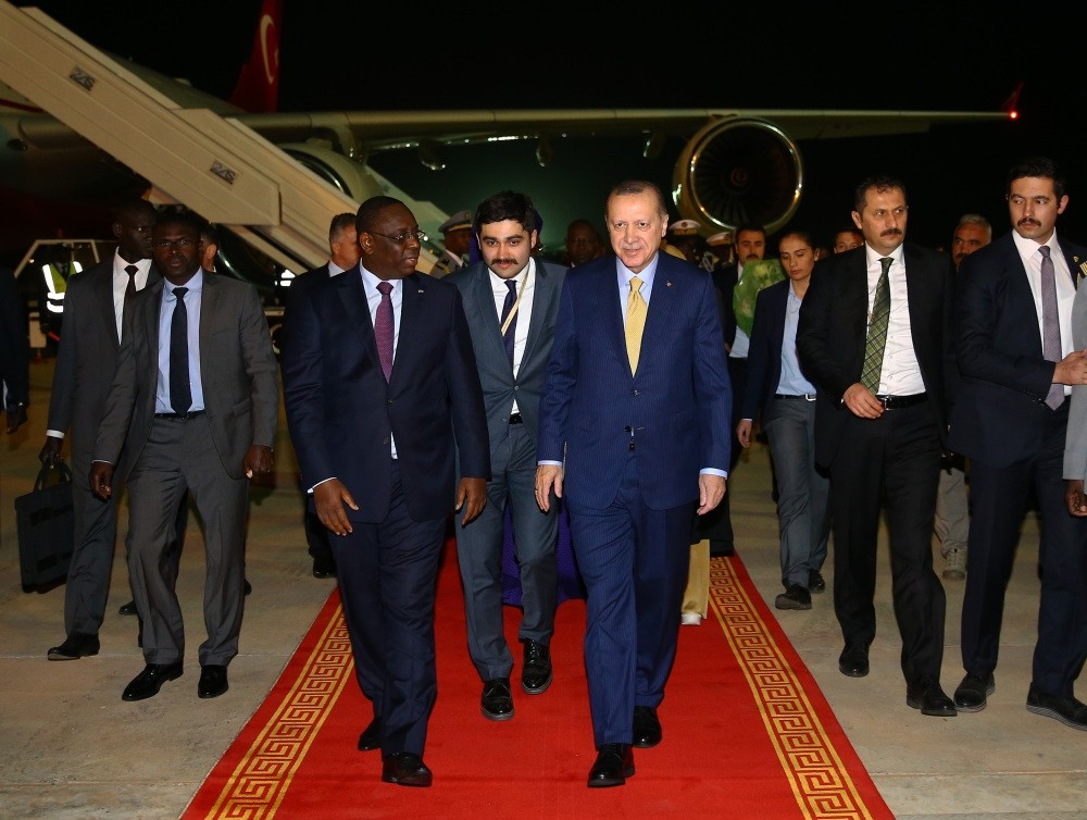 Senegalese President Macky Sall (L) welcomes President Erdou011fan (R) upon his arrival in Senegal, late Wednesday, Feb. 28.
