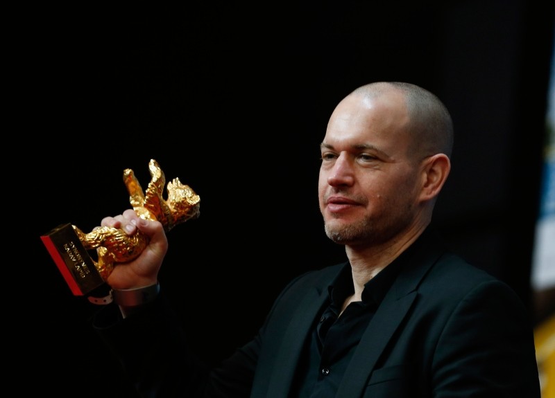 Director Nadav Lapid holds aloft the golden bear for best film for 'Synonyms' onstage at the award ceremony of the 2019 Berlinale Film Festival in Berlin, Germany, Saturday, Feb. 16, 2019. (AA Photo)