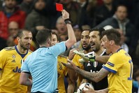 Referee Michael Oliver shows a red card to Juventus goalkeeper Gianluigi Buffon during a Champions League quarter final second leg match between Real Madrid and Juventus at the Santiago Bernabeu stadium, Madrid.