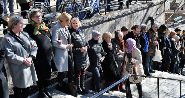 People stand in a protective ring around the Stockholm mosque during Friday prayers, on Friday March 22, 2019, to honour the 50 Muslim worshippers killed one week ago by a gunman in Christchurch, New Zealand. (AA Photo)