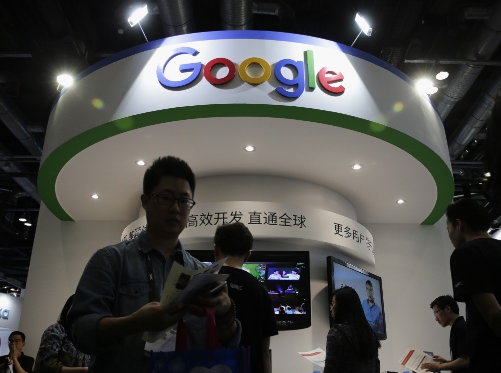Visitors gather at a display booth for Google at the 2016 Global Mobile Internet Conference in Beijing.