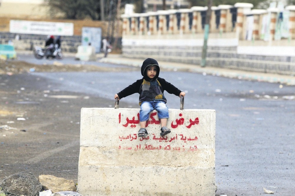 A Yemeni child sits on a concrete barrier on a street in Sanaa, Yemen, April, 7.