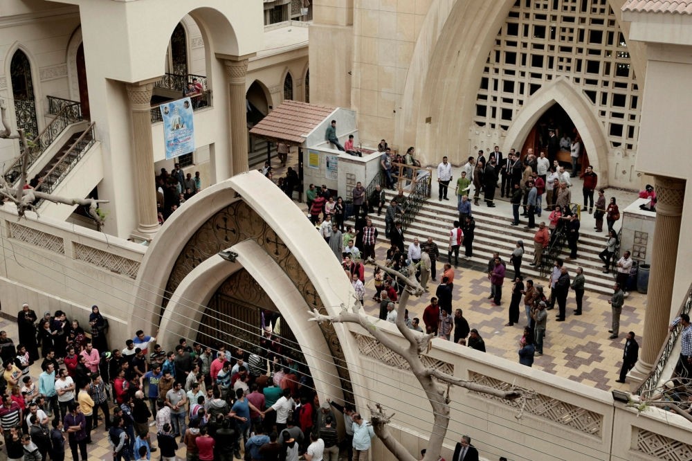 People gather outside St. George's Church after a deadly suicide bombing in the Nile Delta town of Tanta, Egypt, April 9.