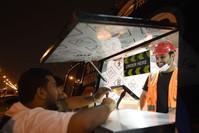 Bader al-Ajmi, 38,(R) owner of ,One Way Burger, serves customers from his truck at a main street in the capital Riyadh.