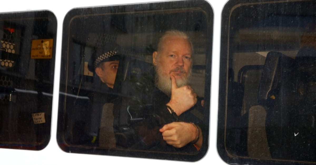WikiLeaks founder Julian Assange is seen in a police van after was arrested by British police outside the Ecuadorian embassy in London, Britain April 11, 2019. (Reuters Photo)