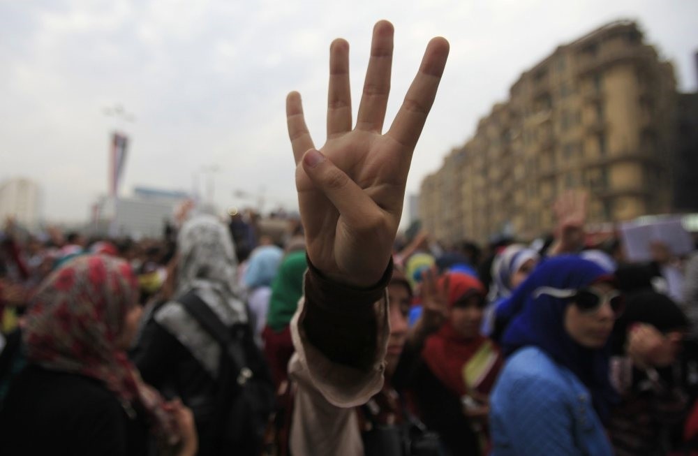 The ,Rabaa,, or ,four,, gesture is in reference to the brutal police clearing of the Rabaa square, which was the pro-Morsi protesters' main area, on Aug.  14, 2013.
