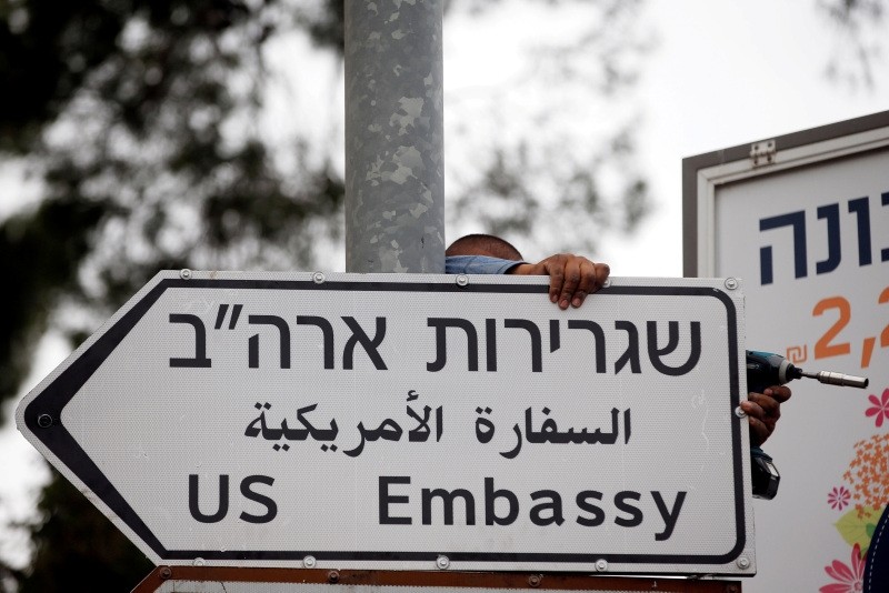 A worker hangs a road sign directing to the U.S. embassy, in the area of the U.S. consulate in Jerusalem, May 7, 2018. (Reuters Photo)