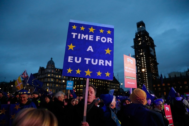 Pro-European demonstrators hold posters at Parliament Square in London, Tuesday, Jan. 15, 2019. (AP Photo)