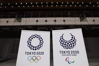 Logos for the Tokyo 2020 Olympics and Paralympics, are displayed at a grand opening ceremony of the Ariake Arena, Tokyo, Feb. 2, 2020. (AP Photo) 