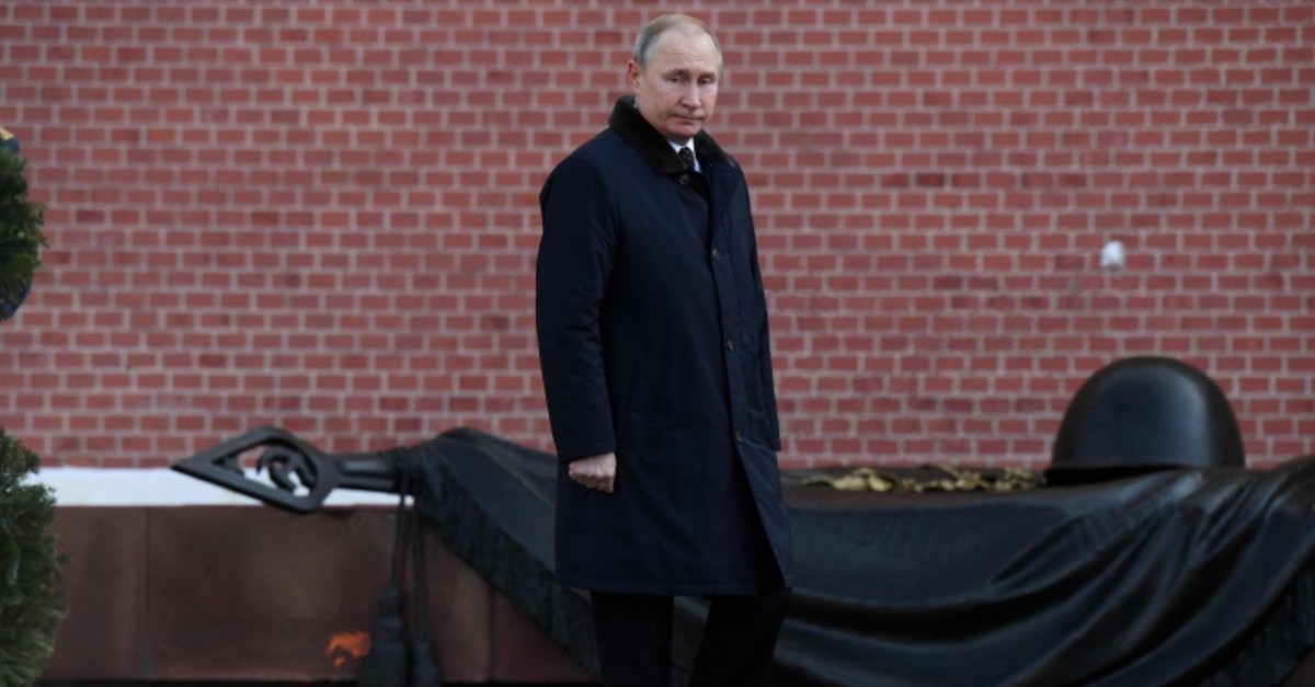 Russian President Vladimir Putin stands during a wreath laying ceremony at the Tomb of the Unknown Soldier by the Kremlin wall to mark the Defender of the Fatherland Day in Moscow on February 23, 2019. (AFP Photo)