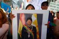 A supporter of Bolivia's President Evo Morales holds a portrait of Morales during a march, in Buenos Aires, Argentina Nov. 8, 2019.  (REUTERS)