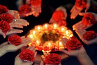 Women apply henna on their palms during a traditional henna night.