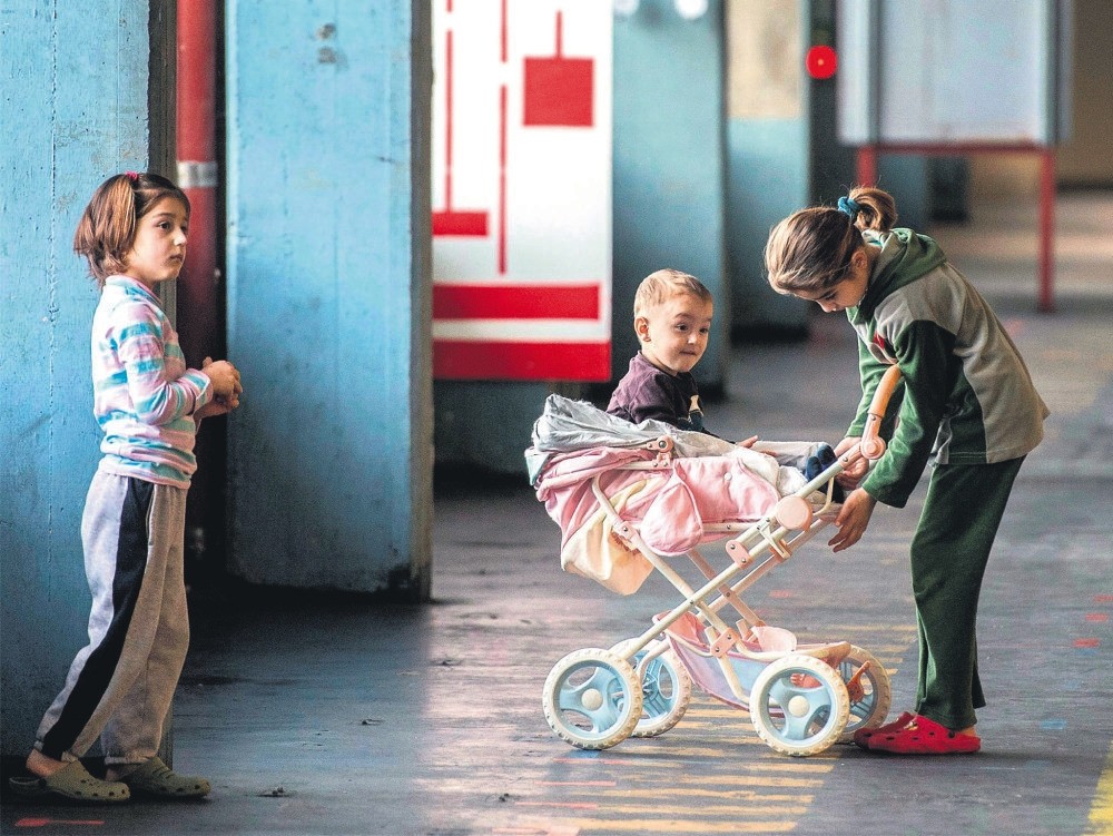 Children play in a building converted into refugee accommodations, Frankfurt, Germany.