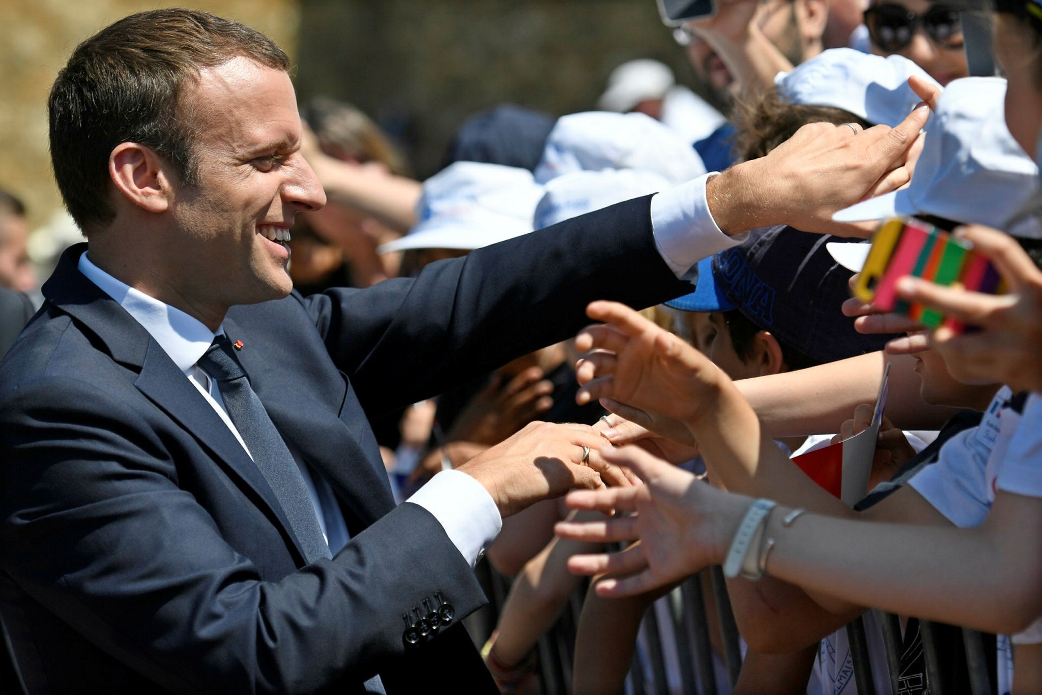 French President Emmanuel Macron shakes hands with people during the ceremony to mark the 77th anniversary of General Charles de Gaulle's appeal of 18 June 1940, at the Mont Valerien memorial in Suresnes, near Paris, France, (EPA Photo)