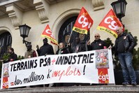 Employees of PSA Peugeot Citroen, hold a banner during a demonstration organised by CGT Union to call to preserve jobs and ask for the reindustrialisation of PSA plant in Aulnay-sous-Bois.The banner reads: u201cPSA fields + industry = thousands of jobsu201d.
