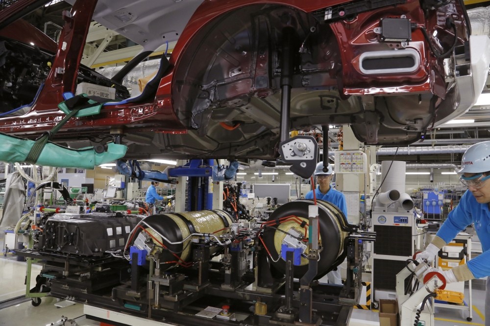 Workers of Toyota Motor Corp. assemble a Mirai fuel cell vehicle at the automaker's Motomachi plant in Toyota, western Japan.