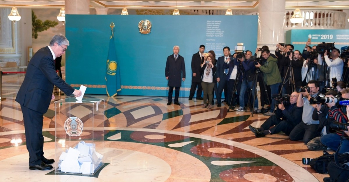 Kazakhstan's acting President Kassym-Jomart Tokayev, left, casts his ballot at a polling station during the presidential elections in Nur-Sultan, the capital city of Kazakhstan, Sunday, June 9, 2019. (AP Photo)