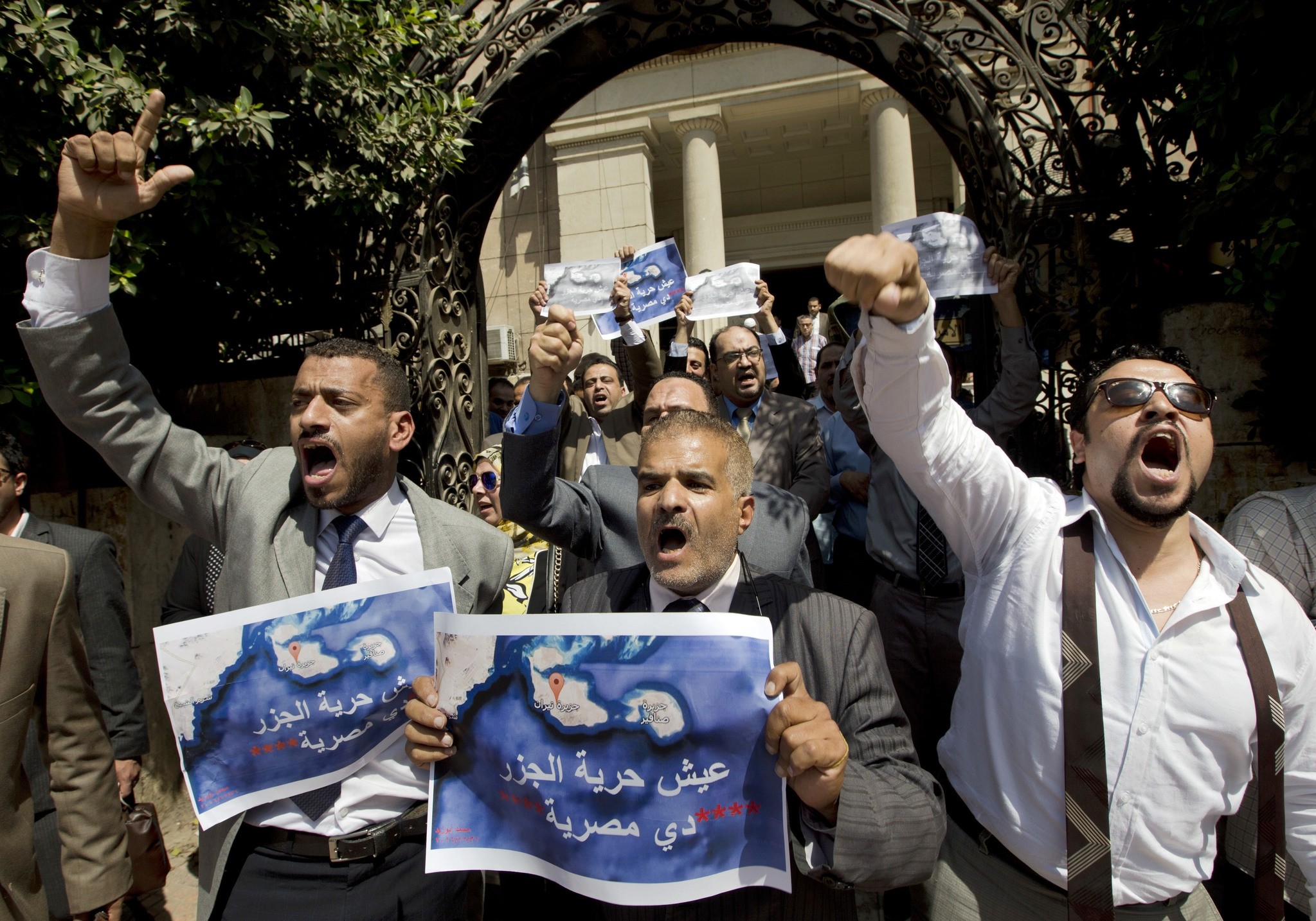 Dozens of lawyers shout slogans during a protest against the accord to hand over control of two strategic Red Sea islands, Tiran and Sanafir, to Saudi Arabia in front of the lawyers syndicate in Cairo. (AP Photo)