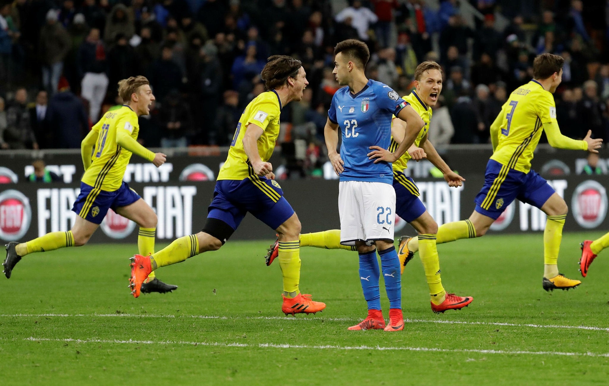 Swedish players run past Italy's Stephan El Shaarawy as they celebrate qualifying at the end of the World Cup qualifying play-off second leg soccer match between Italy and Sweden, at the Milan San Siro stadium, Italy, Monday, Nov.13, 2017. (AP Photo)